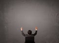 Businessman sitting in front of a wall with copy space Royalty Free Stock Photo