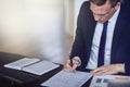 Businessman sitting at his office desk looking over documents Royalty Free Stock Photo