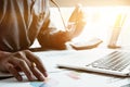 Businessman sitting at his office and using laptop, holding glasses in hand, calculator on desk, Business financial Royalty Free Stock Photo