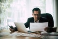 Businessman sitting at his workplace in front of laptop computer while doing some business Royalty Free Stock Photo