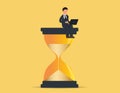 Businessman in sitting on an hourglass and working on laptop.Concept business vector illustration Royalty Free Stock Photo