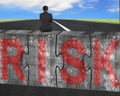 Businessman sitting on huge concrete puzzles with red risk word