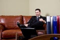 Businessman sitting on leather couch in office