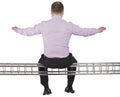Businessman sitting on light metal girder beam on