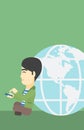 Businessman sitting near Earth globe. Royalty Free Stock Photo