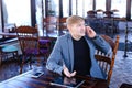 Businessman sitting near table with smartphone and laptop speaki Royalty Free Stock Photo