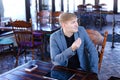 Businessman sitting near table with smartphone and laptop speaki Royalty Free Stock Photo