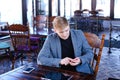 Businessman sitting near table with smartphone and laptop speaki Royalty Free Stock Photo
