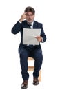 Businessman sitting with newspaper on hand with crazy gesture Royalty Free Stock Photo