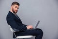 Businessman sitting on the office chair with laptop Royalty Free Stock Photo