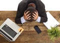 Businessman sitting at office desk with hands on his head crying devastated and frustrated Royalty Free Stock Photo