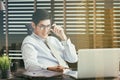 Businessman sitting at office desk with laptop computer