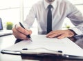 Businessman sitting at office desk signing a contract close up Royalty Free Stock Photo