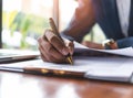 Businessman sitting at office desk signing a contract close up Royalty Free Stock Photo