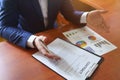 Businessman sitting at office desk signing a contract with shallow focus on signature Royalty Free Stock Photo