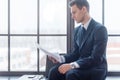 Businessman sitting in office reading contract documents Royalty Free Stock Photo