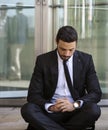 Businessman sitting outside on the curb and waiting Royalty Free Stock Photo