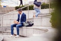 Businessman Sitting Outside On Lunch Break Eating Takeaway Meal From Sustainable Recyclable Carton