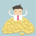 Businessman sitting in a pile of gold coins Royalty Free Stock Photo