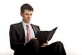 Businessman sitting and reading computer tablet