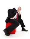 Businessman sitting on red tabouret Royalty Free Stock Photo