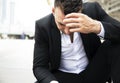 Businessman sitting sadness and thinking work on walking street.