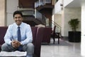 Businessman Sitting On Sofa In Hotel Lobby Royalty Free Stock Photo