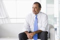 Businessman sitting on sofa in lobby Royalty Free Stock Photo