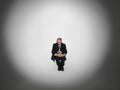 Businessman Sitting In Spotlight Royalty Free Stock Photo