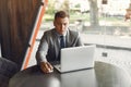 Businessman sitting at thecafe with laptop Royalty Free Stock Photo