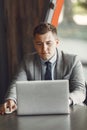 Businessman sitting at thecafe with laptop Royalty Free Stock Photo