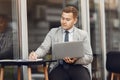 Businessman sitting at thecafe with laptop Royalty Free Stock Photo