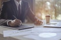 Businessman sitting to working at office desk have a coffee cup beside for efficient work problems and concepts.