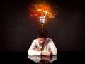 Businessman sitting under a blowing idea bulb Royalty Free Stock Photo