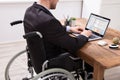 Businessman Sitting On Wheelchair Using Laptop Royalty Free Stock Photo