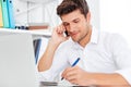 Businessman sitting at workplace and talking on the mobile phone Royalty Free Stock Photo