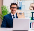 Businessman with skateboard in office