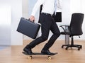 Businessman On Skateboard In Office