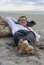 Businessman sleeping on a beach Royalty Free Stock Photo