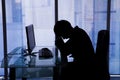 Businessman sleeping at computer desk in office Royalty Free Stock Photo