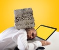 Businessman sleeping on a computer. Stress and overwork concept. Yellow background Royalty Free Stock Photo