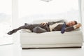 Businessman sleeping on couch in living room Royalty Free Stock Photo
