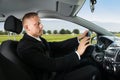 Businessman sleeping while driving car Royalty Free Stock Photo