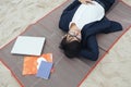 Businessman sleeping on a mat at the beach Royalty Free Stock Photo