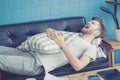 Businessman with sleeping on sofa with book on table at home. Royalty Free Stock Photo