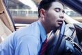 Businessman sleeping on the steering wheel Royalty Free Stock Photo