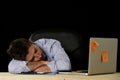 Businessman sleeping wasted and tired at office computer desk in long hours of work Royalty Free Stock Photo