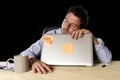 Businessman sleeping wasted tired at office computer desk in long hours of work Royalty Free Stock Photo