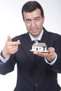 Businessman with a small house in his hand Royalty Free Stock Photo