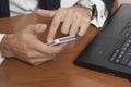 Businessman with a smart phone and laptop